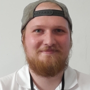 a smiling bearded man
