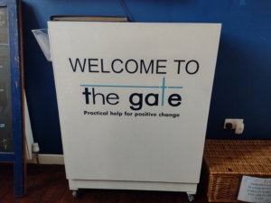 a plinth with welcome to the gate on it
